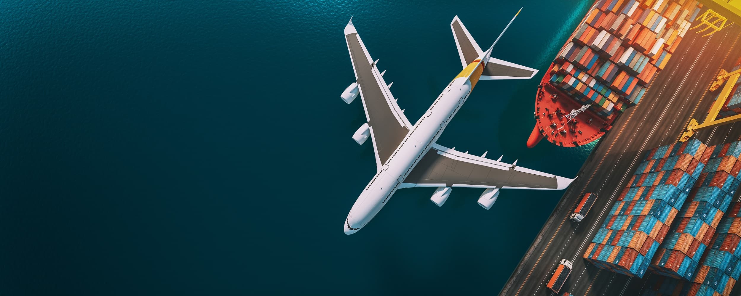Aerial view of a freighter aircraft over a container port